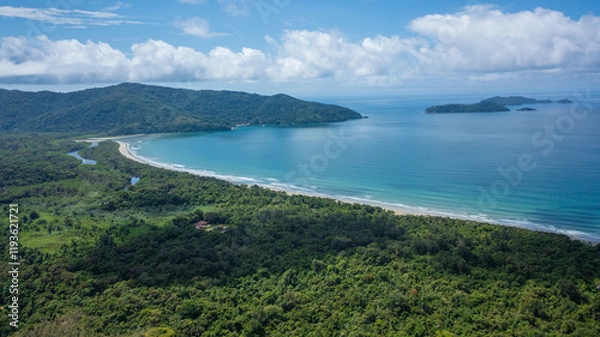 Fototapeta Beautiful aerial view of a preserved area, Fazenda Beach, within the Serra do Mar State Park, a destination for sustainable and ecological tourism in Atlantic Rainforest, between Montains and Sea.