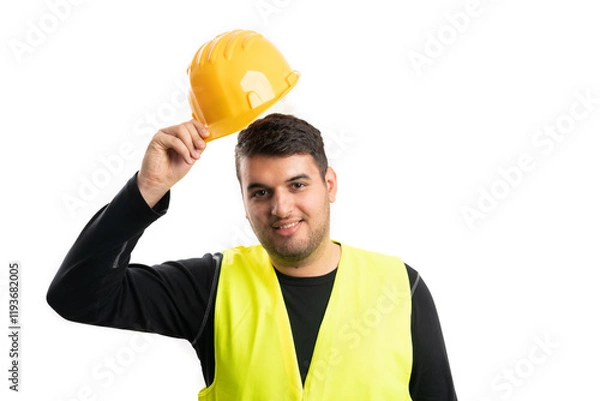 Fototapeta Builder man with friendly expression taking off helmet gesture