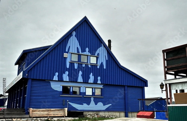 Obraz Greenland. Colorful houses dot the rugged coastline of a remote settlement in Greenland during a cloudy day
