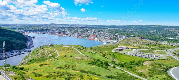 Fototapeta Panoramic views with bight blue summer day sky with puffy clouds over the harbour and city of St. John's Newfoundland, Canada.