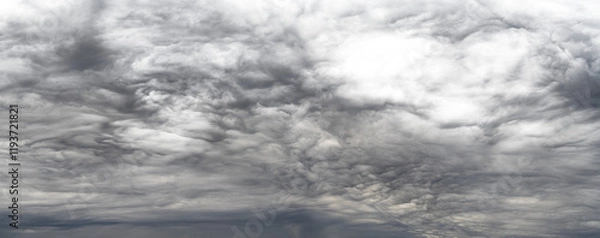 Fototapeta Panorama of dramatic storm clouds that fade to transparent in light areas near top right
