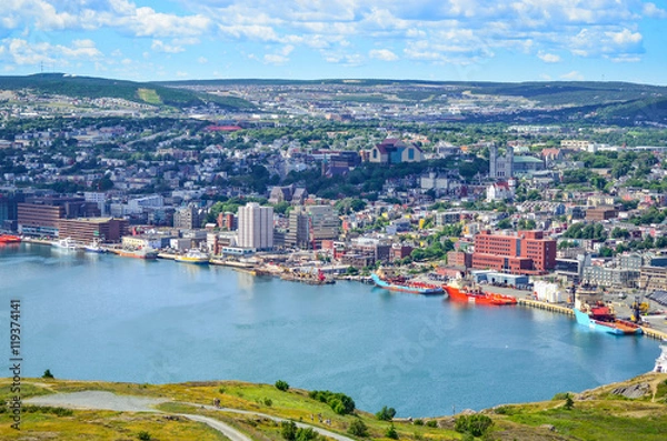 Fototapeta Panoramic views with bight blue summer day sky with puffy clouds over the harbour and city of St. John's Newfoundland, Canada.