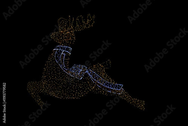 Obraz Deer illuminated with colorful lights with Christmas motivation on top of a public park. 
