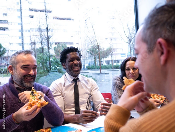 Fototapeta From the perspective of a man in a beige sweater, three colleagues with pizzas look at him while laughing. A phone is on the table, and rain falls outside the bright office window