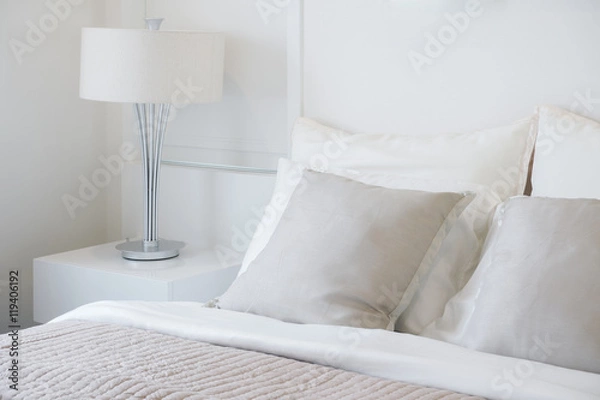Fototapeta Light gray pillow setting on bed in nice vibe bedroom modern interior style