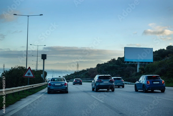 Obraz Traffic jam on the highway in the evening with empty billboard.