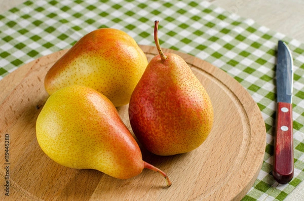 Obraz Ripe pear and a knife on wooden Board