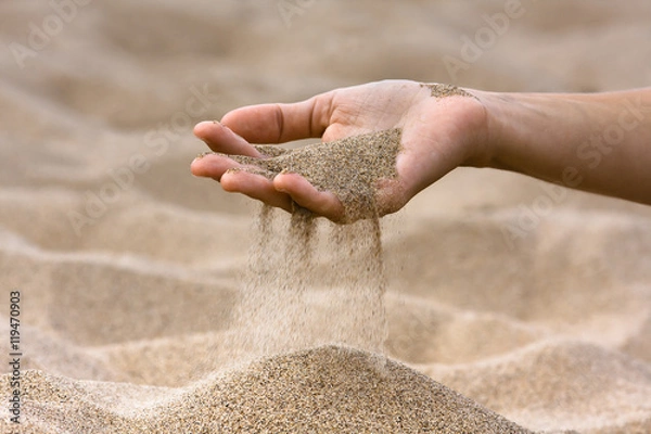 Obraz sand running through hand of woman