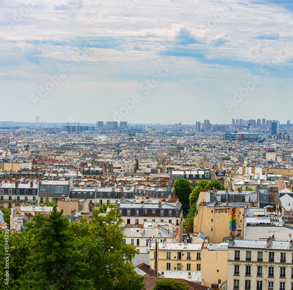 Fototapeta Parisian neighborhood with the different roof styles in the summer sun .