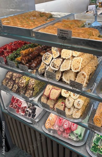 Fototapeta Showcase with assorted oriental sweets, featuring vibrant colors and intricate details, perfect for food promotions, menus, or cultural themes