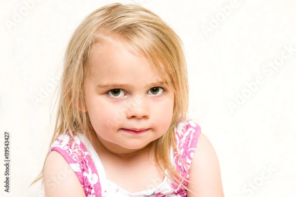 Fototapeta Closeup Headshot Portrait of Beautiful Toddler Girl with Mischevious Expression