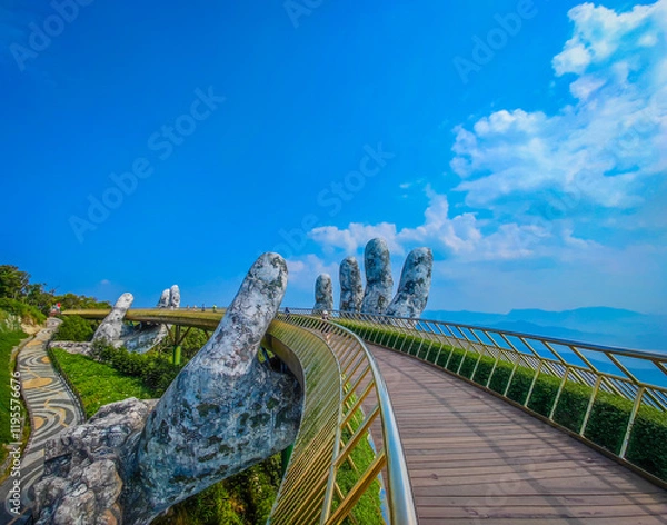 Obraz Empty Golden Bridge in Ba Na hills, Da Nang, Vietnam on a sunny day. Lifted by two giant concrete hands. Iconic world famous bridge in the mountains