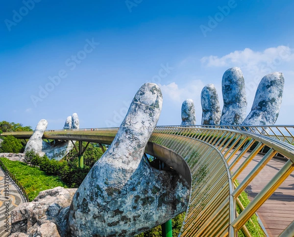 Obraz Golden Bridge in Ba Na hills, Da Nang, Vietnam on a sunny day. Lifted by two giant concrete hands. Iconic world famous bridge in the mountains
