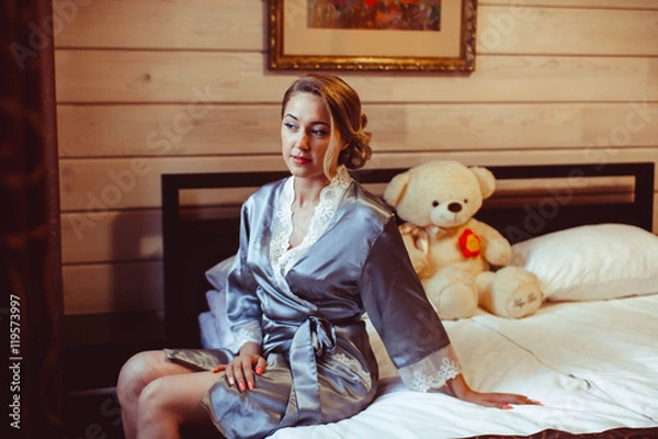 Obraz girl sitting on bed in Bathrobe