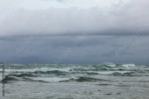 Obraz stormy waves crashing on the sea with a dark sky background