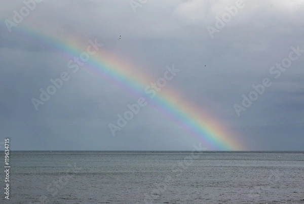 Obraz Rainbow over the sea with storm clouds