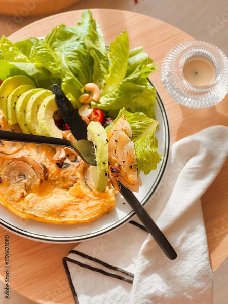 Obraz Onion omelette with avocado for breakfast. Delicious food. Cooking recipes. Bruch menu. Healthy recipes. Easy home cooking. Diet food dish. High Protein. eggs recipe. Breakfast tray. Fluffy omelet. 