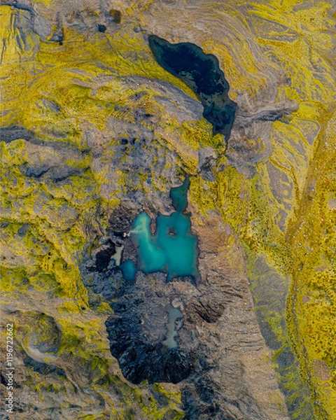 Fototapeta Aerial view of turquoise ponds in a mossy canyon, South Iceland's rugged terrain.