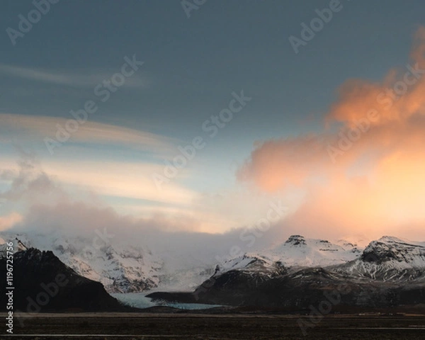 Fototapeta Vivid sunrise over snow-covered mountains in Öræfi, South Iceland.