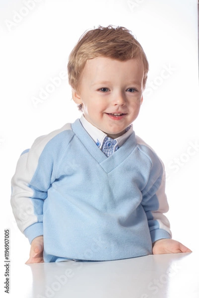 Obraz Emotional baby in shirt and blue jumper on white background
