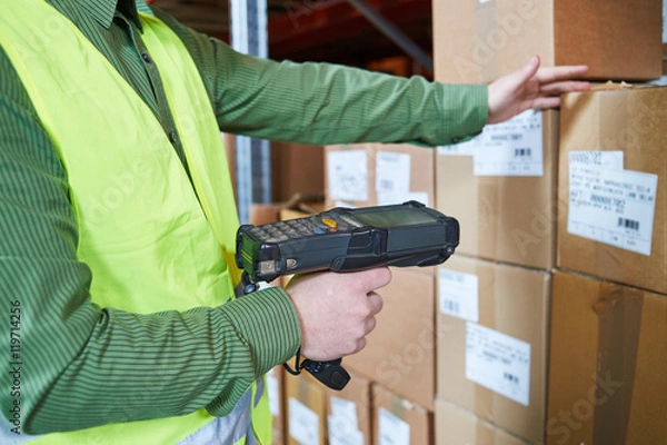 Fototapeta Warehouse Management System. Worker with barcode scanner