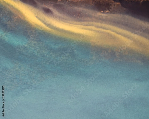 Fototapeta Aerial view of Olfusa River in South Iceland showcasing vivid turquoise and yellow hues...