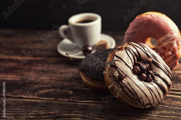 Fototapeta fresh donut with coffee on wooden table with napkin, spoon and c