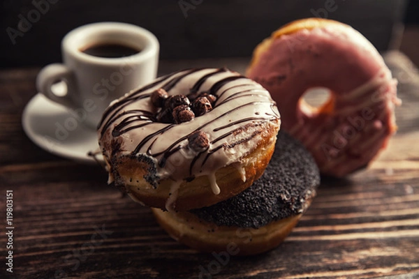 Fototapeta fresh donut with coffee on wooden table with napkin, spoon and c