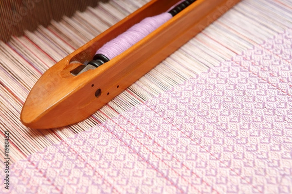 Fototapeta Weaving shuttle on the warp