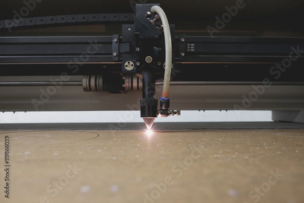 Obraz Laser cutting machine carving patterns on the plastic plate.