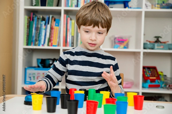 Obraz Color cap game. Sorting, counting, building. Children activities. Logical tasks for kids. Concentration and attention, patience, Montessori methodology. pursuit of the goal, strategy, new challenge.
