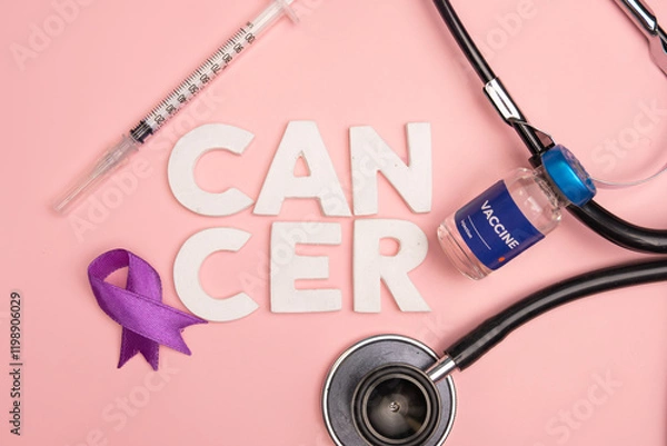 Obraz A vaccine vial and medical tools lay near the word cancer and a purple ribbon. World cancer day concept background