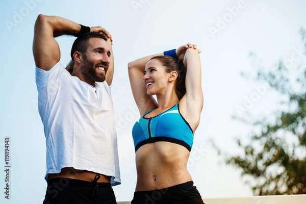 Obraz Happy couple exercising outdoors.