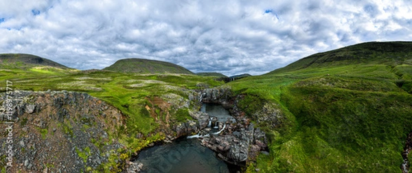 Fototapeta Panorama image of an icelandic river canyon shot in summer with overcast sky