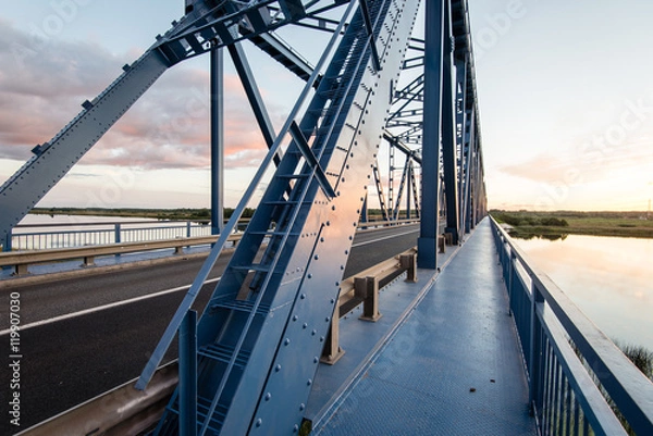 Fototapeta railway bridge with metal rails near river