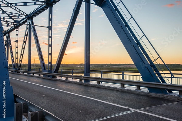 Fototapeta railway bridge with metal rails near river
