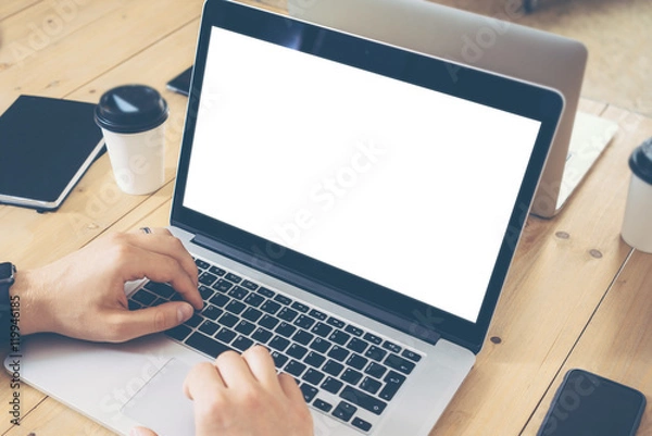 Fototapeta Young Businessman Working Process Business Startup Online Trade Markets.Marketing Manager Using Electronic Device.Creative People Work New Project Wood Table.Notebook,Tablet,Smartphone Blurred Closeup