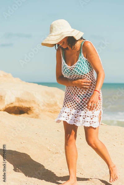 Obraz A Latina woman laughing on a beach afternoon in a crochet dress