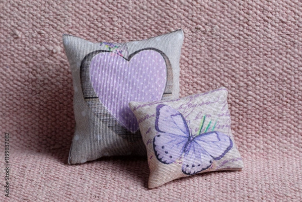 Obraz Cushions with butterfly and pink heart on sofa