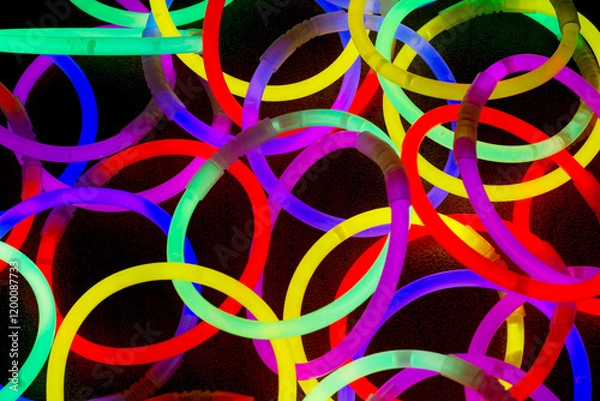 Fototapeta Chemical glow circles in rainbow colors on a black background