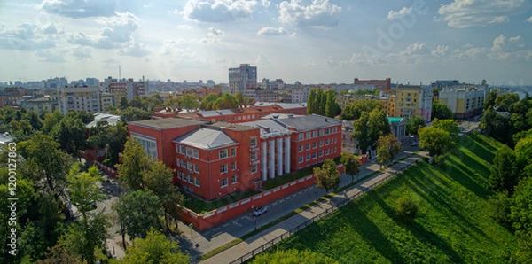 Fototapeta City view with a large red building in the center