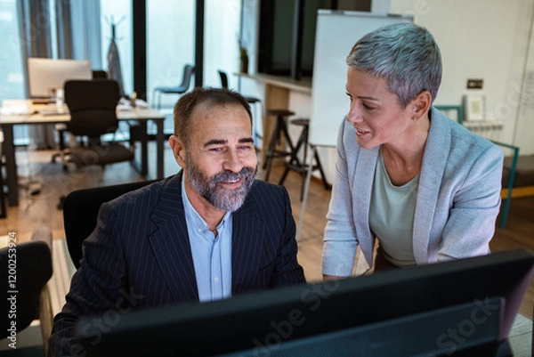 Obraz Team collaboration at office desk with dual monitors and brainstorming