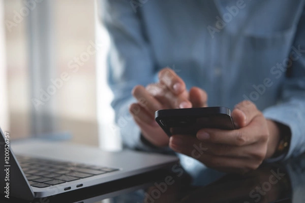 Fototapeta Close up, business woman using mobile smart phone searching the information, surfing the internet during working on laptop computer at office, social media marketing
