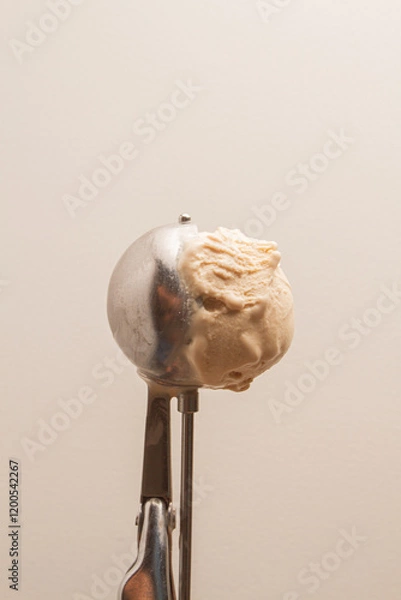 Fototapeta ice cream scoop with ice cream, beige background