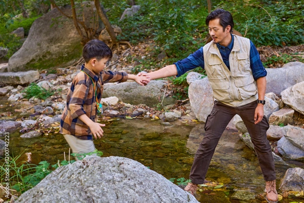 Obraz Teacher and kids having fun by the stream
