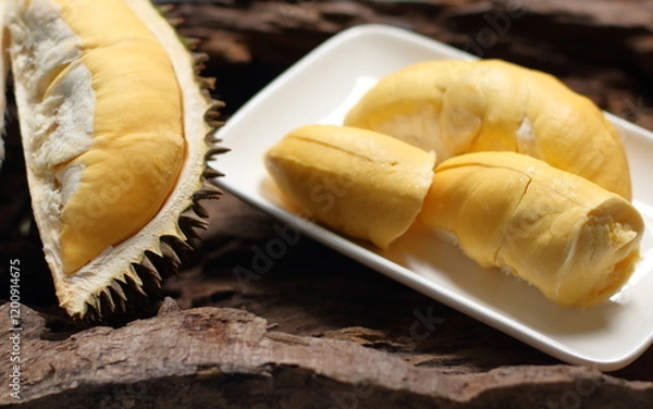Fototapeta Durian in a white plate on a wooden background