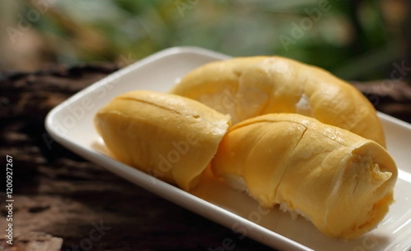 Fototapeta Durian in a white plate on a wooden background