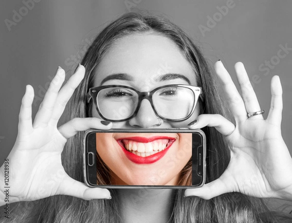 Obraz dziewczyna ze smartfonem robienie zdjęć do jej uśmiechu