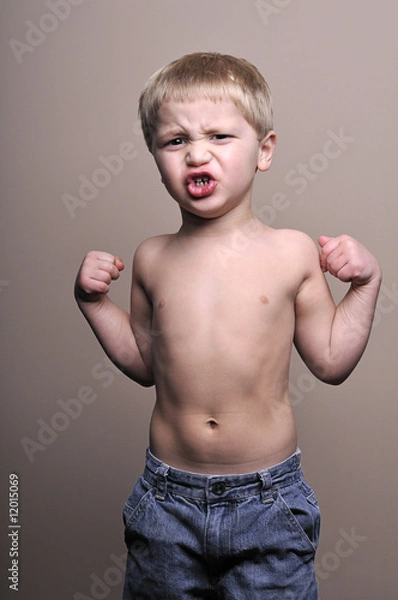 Fototapeta Little boy flexing muscles