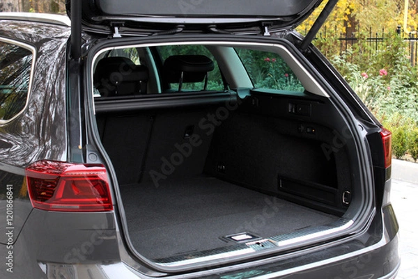 Fototapeta Huge empty trunk of a wagon car.  Open back door modern car. Car boot is open. Wagon clean trunk. Modern wagon car open trunk. Right view.